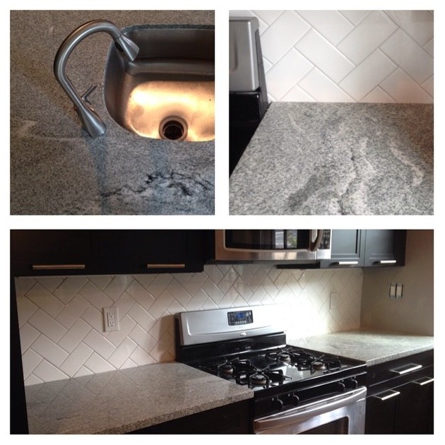Mid-sized transitional u-shaped light wood floor eat-in kitchen photo in Baltimore with an undermount sink, recessed-panel cabinets, black cabinets, granite countertops, white backsplash, stainless steel appliances, a peninsula, gray countertops and subway tile backsplash