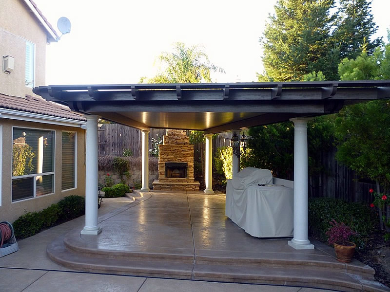 This is an example of a mid-sized traditional backyard patio in Sacramento with stamped concrete and an awning.
