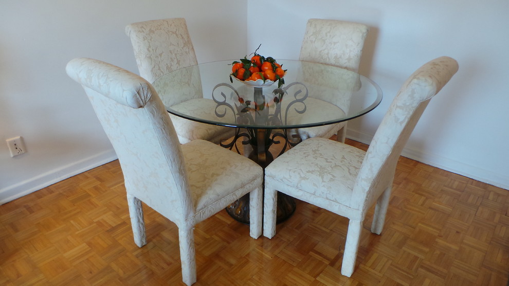 Mid-sized traditional dining room in Toronto with white walls and light hardwood floors.
