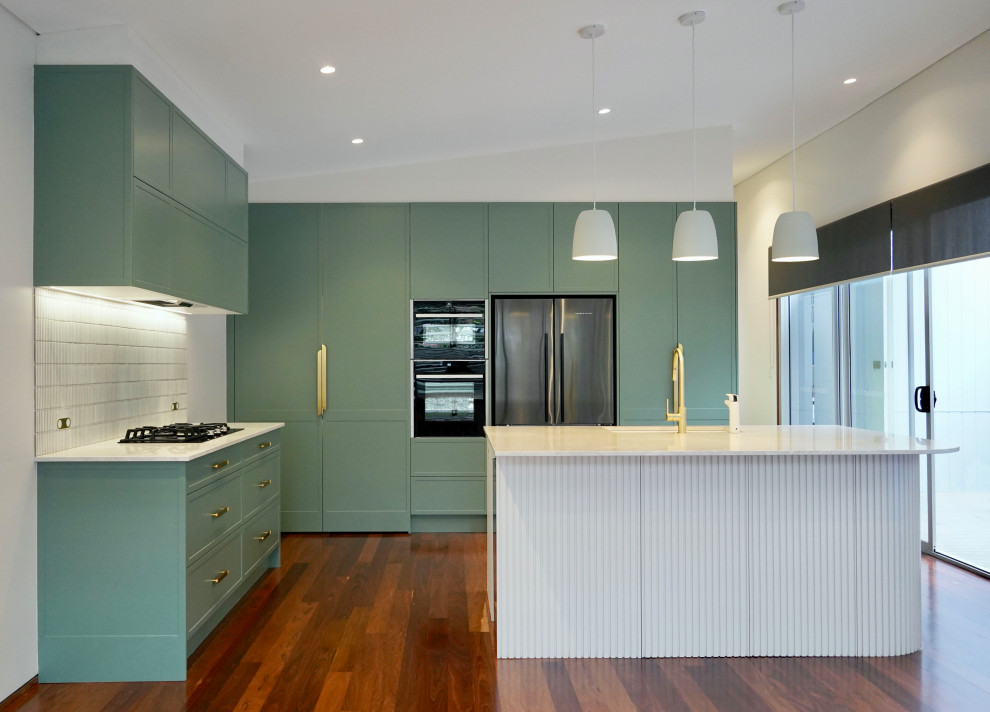 Design ideas for a large modern l-shaped open plan kitchen in Sydney with a submerged sink, shaker cabinets, turquoise cabinets, marble worktops, white splashback, matchstick tiled splashback, black appliances, dark hardwood flooring, an island, brown floors and white worktops.