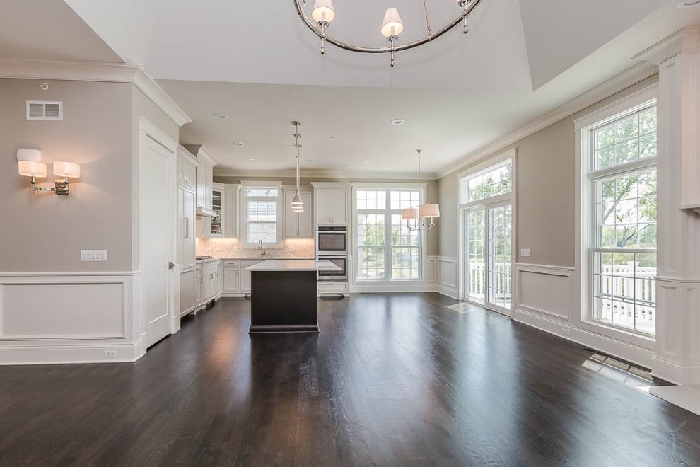 Inspiration for a mid-sized transitional l-shaped dark wood floor eat-in kitchen remodel in Chicago with shaker cabinets, white cabinets, gray backsplash, stone tile backsplash, stainless steel appliances and an island