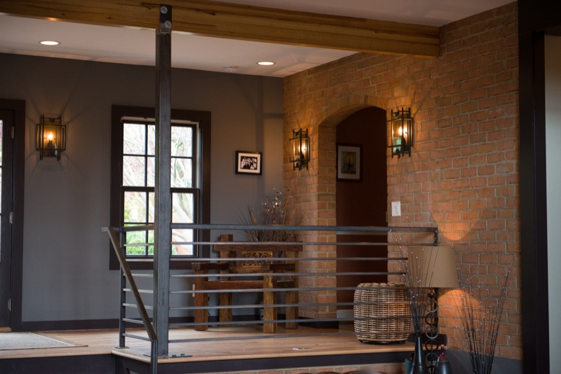 Inspiration for a mid-sized medium tone wood floor vestibule remodel with brown walls
