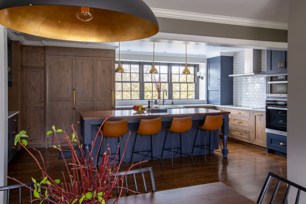 Example of a transitional kitchen design in New York with an island
