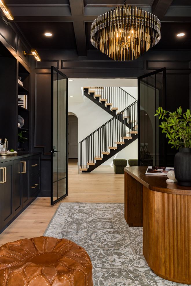 Transitional light wood floor, beige floor, coffered ceiling and wall paneling home office photo in Tampa with black walls