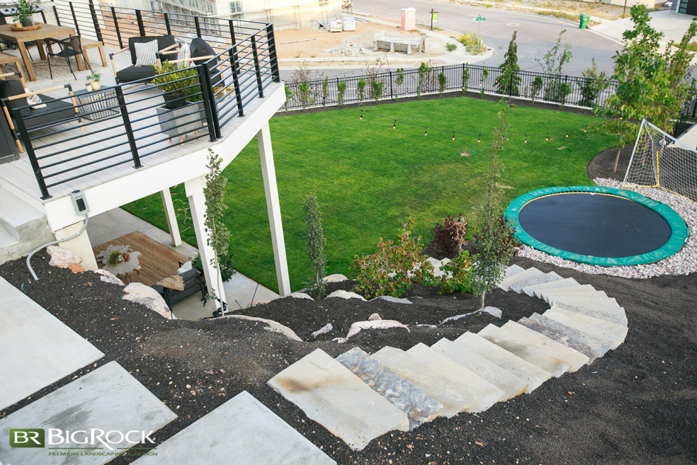 This is an example of a large modern backyard garden in Salt Lake City with with outdoor playset and decking.