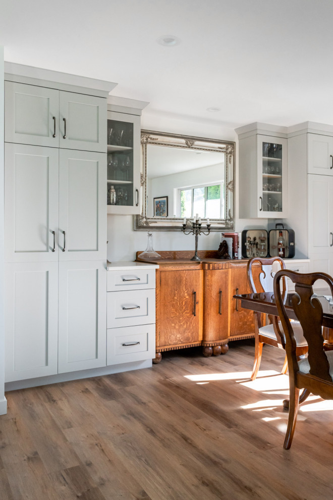 Example of a mid-sized transitional dark wood floor and brown floor kitchen/dining room combo design with white walls