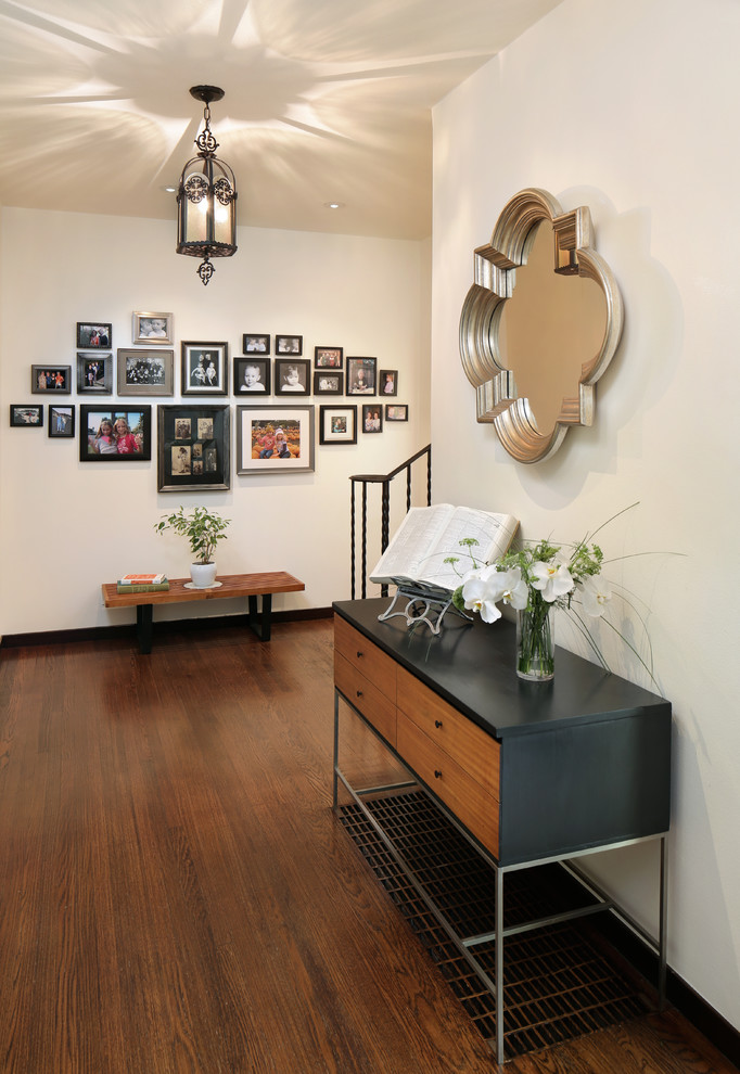 Inspiration for a mid-sized transitional foyer in San Diego with white walls and dark hardwood floors.