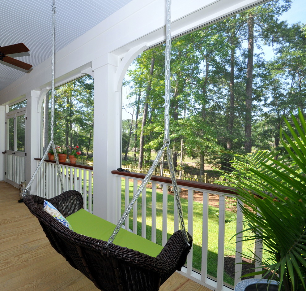 Design ideas for a large traditional backyard screened-in verandah in Charleston with a roof extension.