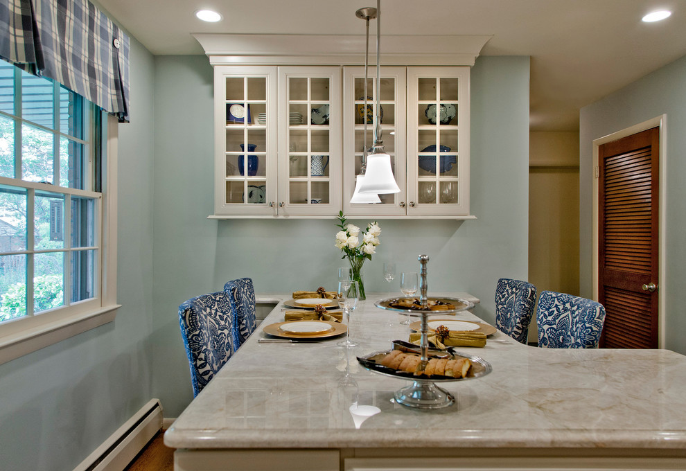 Example of a mid-sized transitional l-shaped light wood floor and brown floor eat-in kitchen design in Baltimore with recessed-panel cabinets, white cabinets, marble countertops, a peninsula, an undermount sink, white backsplash, mosaic tile backsplash and stainless steel appliances