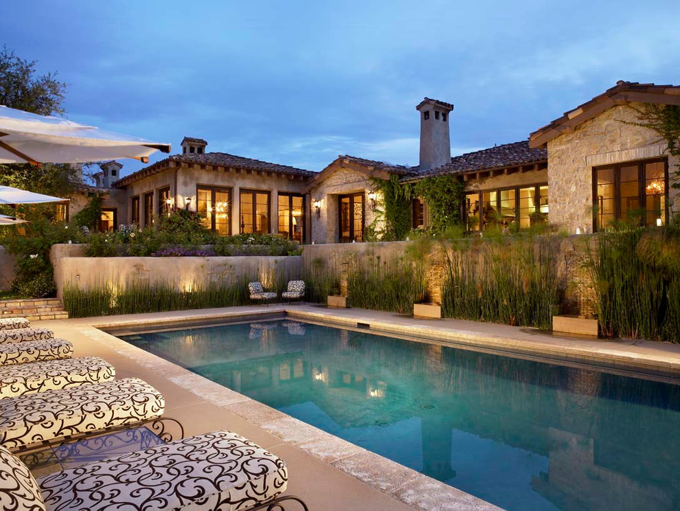 This is an example of a mediterranean backyard rectangular pool in Orange County.