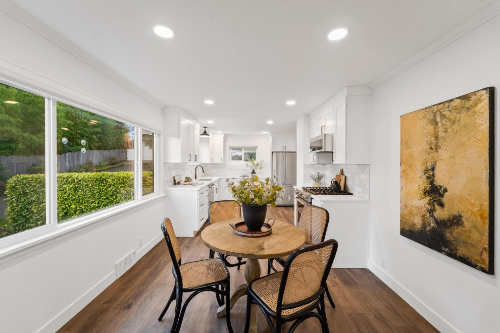Transitional galley dark wood floor and brown floor eat-in kitchen photo in Seattle with an undermount sink, shaker cabinets, white cabinets, quartzite countertops, gray backsplash, ceramic backsplash, stainless steel appliances, no island and white countertops