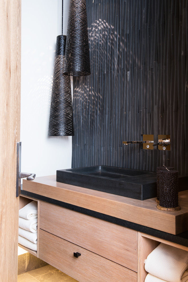 Vail Ski Haus - Powder room - contemporary powder room idea in Denver with a vessel sink, flat-panel cabinets, light wood cabinets and black walls
