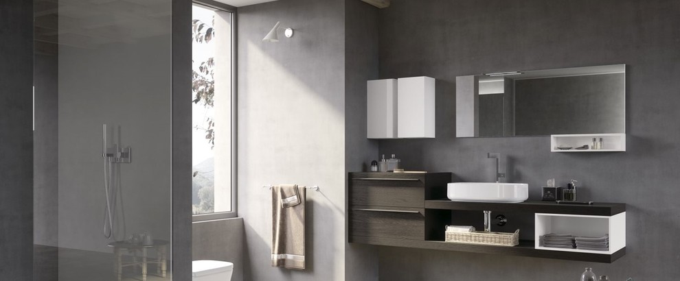 Photo of a large modern master bathroom in Paris with beaded inset cabinets, grey cabinets, a drop-in tub, an open shower, a wall-mount toilet, gray tile, marble, multi-coloured walls, ceramic floors, a console sink and tile benchtops.