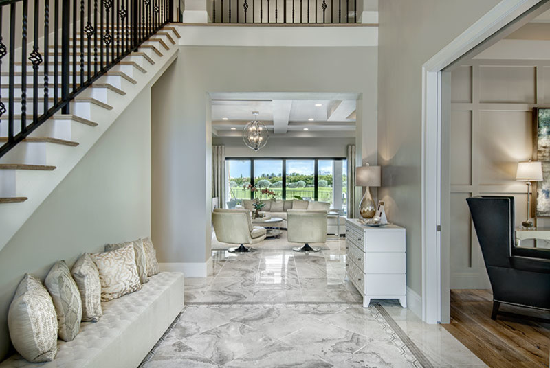 Inspiration for a large mediterranean foyer in Miami with grey walls, ceramic floors and a dark wood front door.