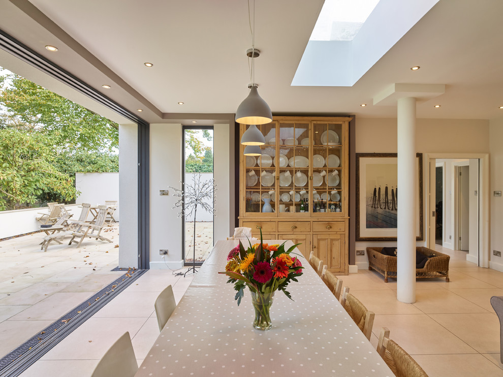 Photo of a contemporary dining room in West Midlands with white walls and beige floor.
