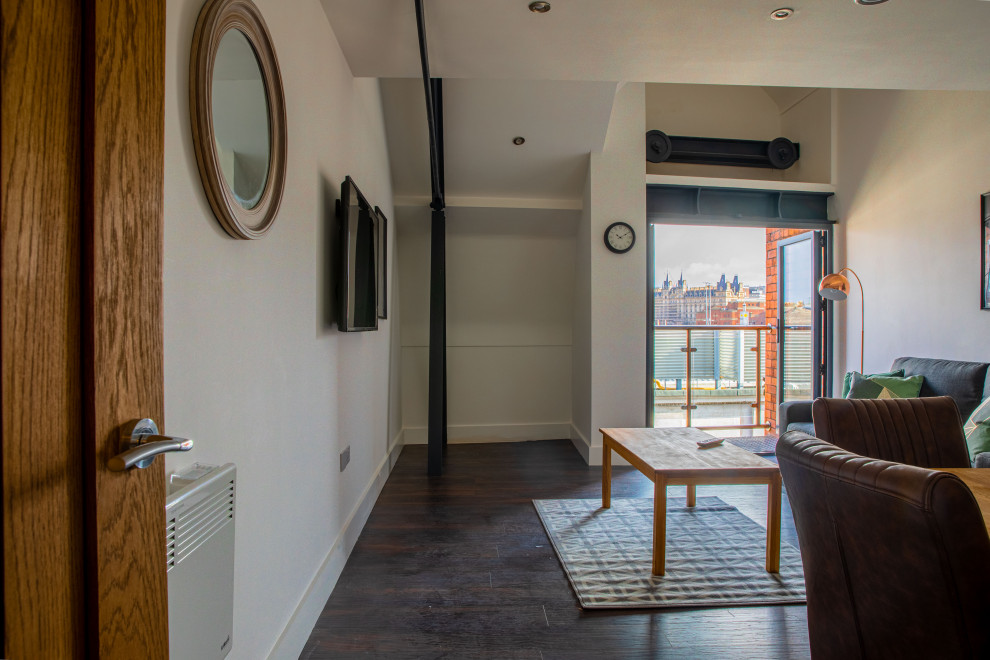 Design ideas for an expansive contemporary formal open plan living room with white walls, dark hardwood flooring, a two-sided fireplace, a brick fireplace surround, a concealed tv, brown floors, exposed beams and panelled walls.