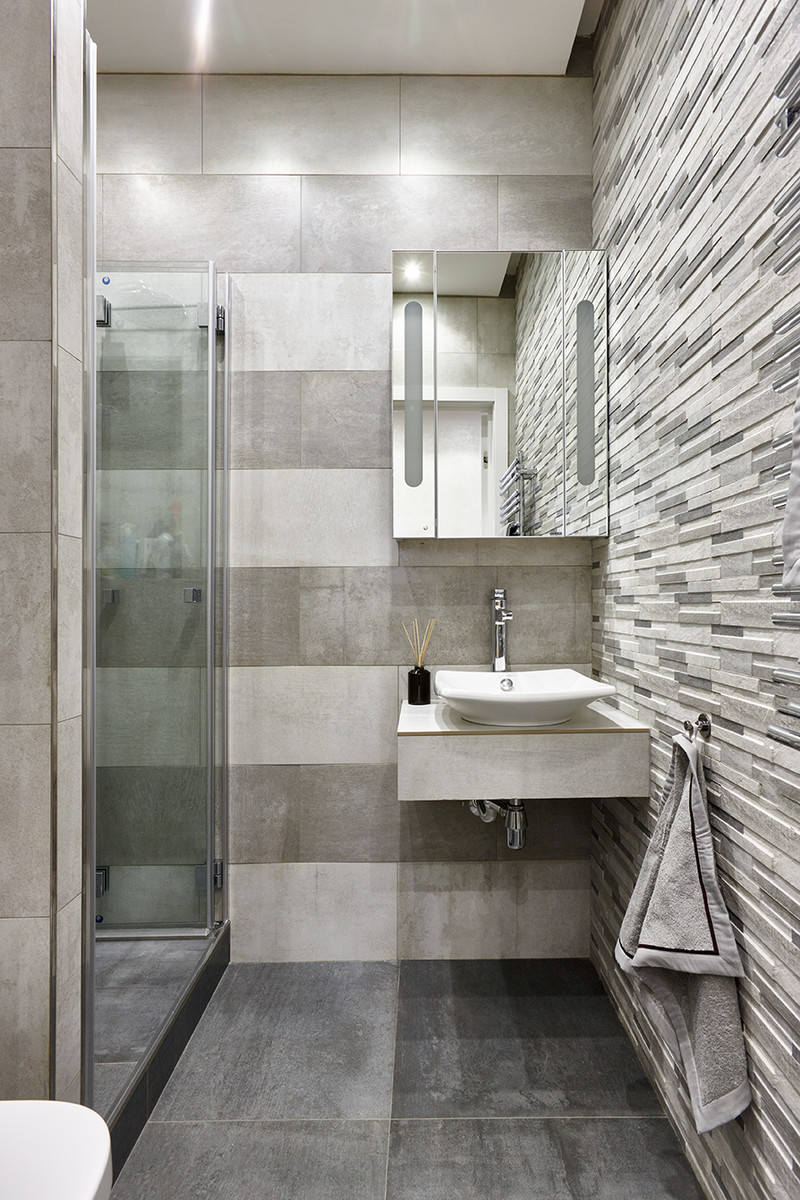 Inspiration for a contemporary 3/4 bathroom in Moscow with flat-panel cabinets, an alcove shower, gray tile, a vessel sink, grey floor and a hinged shower door.