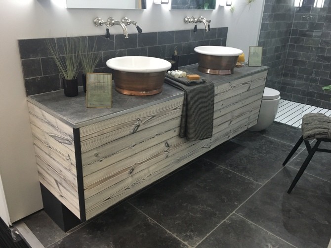 Photo of a mid-sized eclectic master bathroom in Buckinghamshire with raised-panel cabinets, white cabinets, a double shower, gray tile, stone tile, white walls, travertine floors, a trough sink and limestone benchtops.