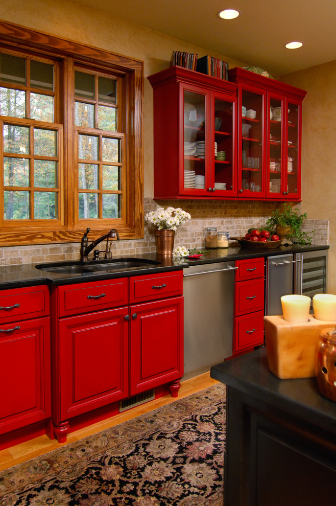 Inspiration for a country kitchen in Charlotte with glass-front cabinets, red cabinets, granite benchtops, beige splashback and with island.