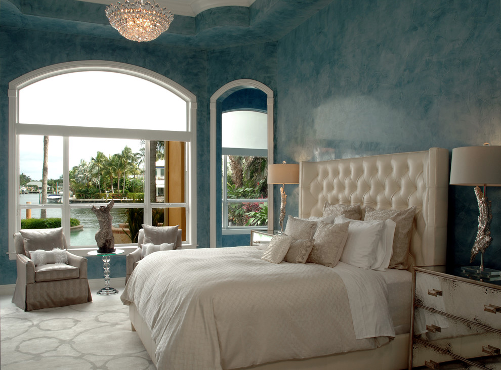 Large transitional master carpeted bedroom photo in Miami with blue walls