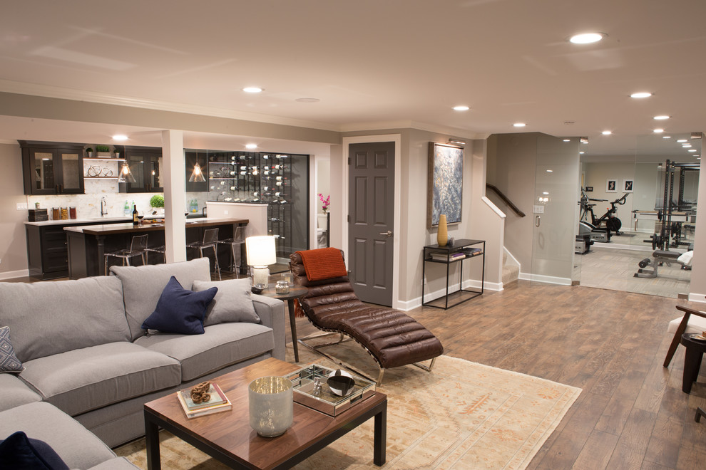 Inspiration for a large transitional fully buried basement in Chicago with beige walls, medium hardwood floors and brown floor.