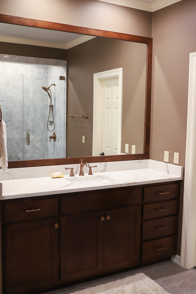 Large transitional master white tile and marble tile porcelain tile and gray floor corner shower photo with shaker cabinets, dark wood cabinets, an undermount tub, a one-piece toilet, brown walls, an undermount sink, quartz countertops, a hinged shower door and white countertops