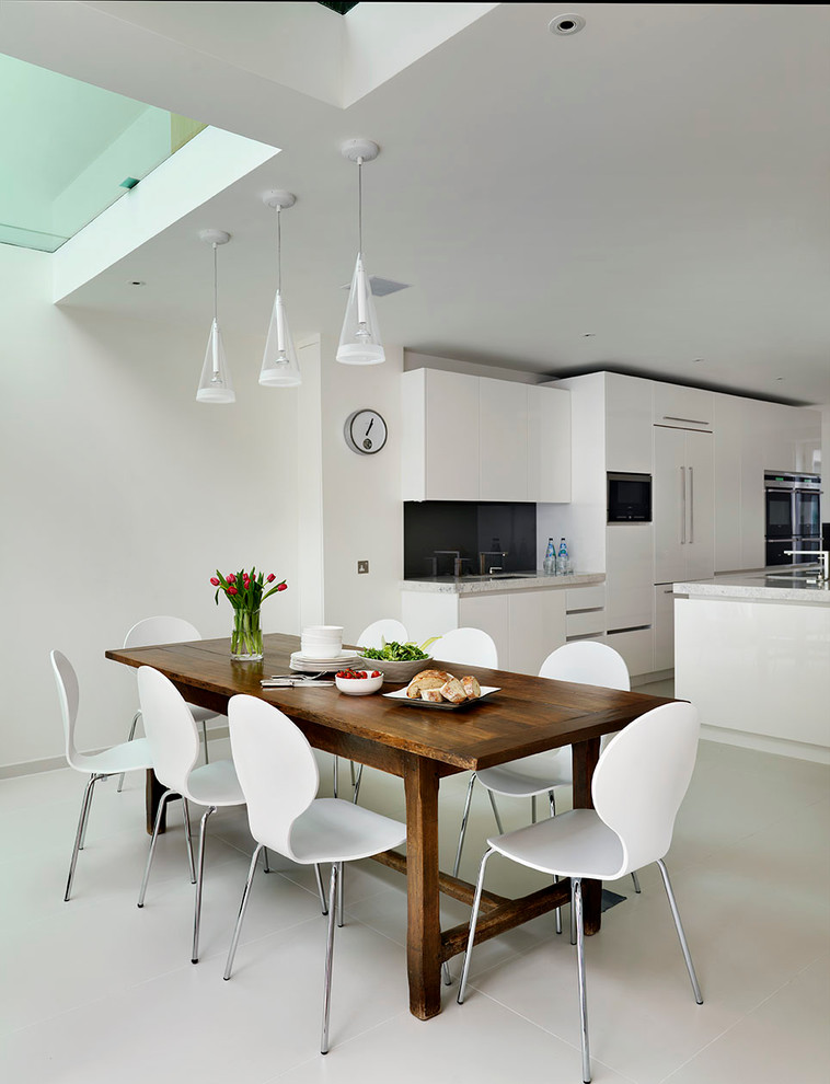 Design ideas for a large contemporary kitchen/dining combo in London with white walls.