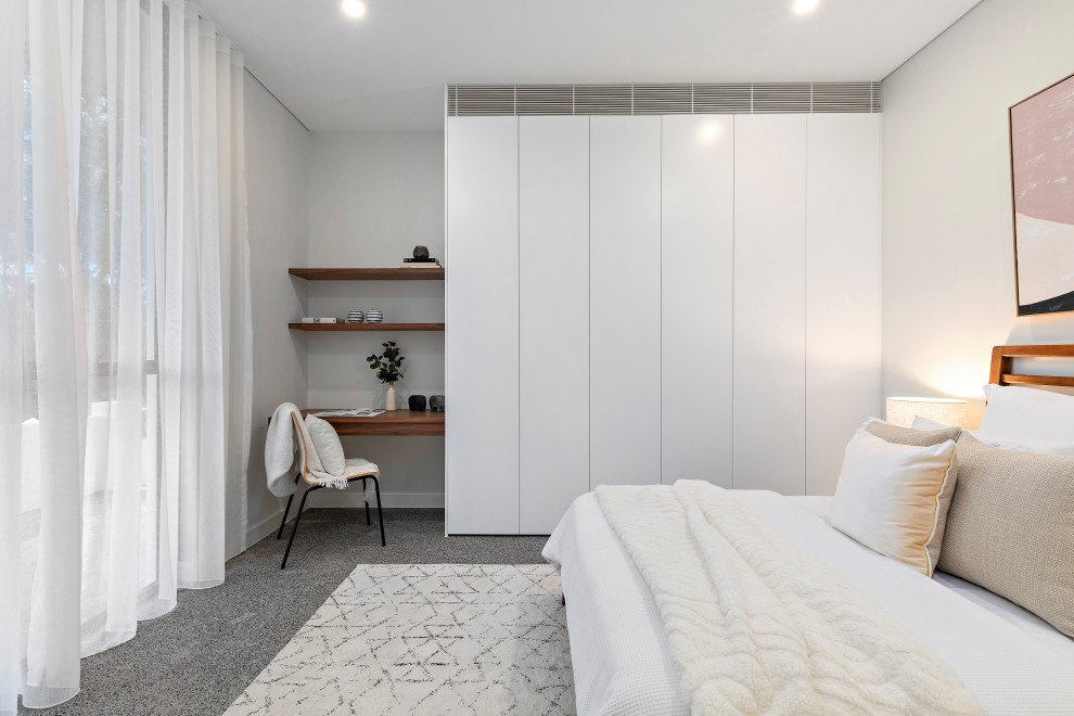 Design ideas for a modern guest bedroom in Sydney with carpet.