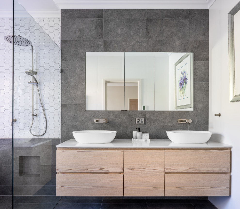 This is an example of a mid-sized contemporary bathroom in Perth with flat-panel cabinets, light wood cabinets, a freestanding tub, an open shower, engineered quartz benchtops, an open shower, white benchtops, a double vanity and a floating vanity.