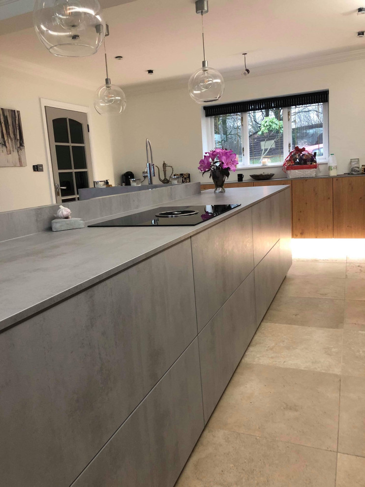 Inspiration for a mid-sized modern single-wall eat-in kitchen in Cardiff with an integrated sink, flat-panel cabinets, grey cabinets, laminate benchtops, stainless steel appliances, ceramic floors, with island, beige floor and grey benchtop.
