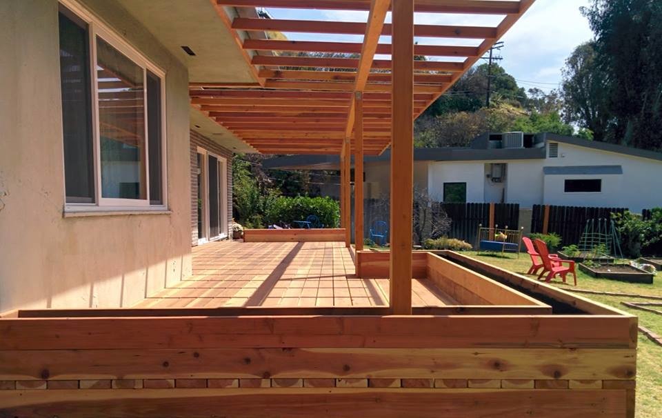 Photo of a small arts and crafts backyard deck in Los Angeles with a container garden and a pergola.