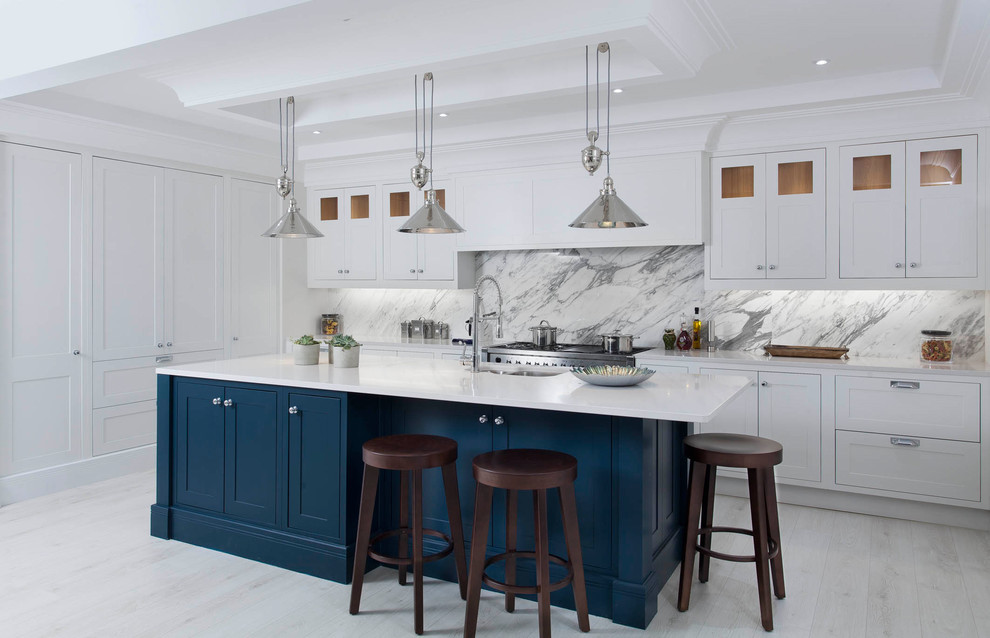 Medium sized classic l-shaped open plan kitchen with a submerged sink, shaker cabinets, grey cabinets, quartz worktops, grey splashback, marble splashback, stainless steel appliances, light hardwood flooring, an island and white floors.