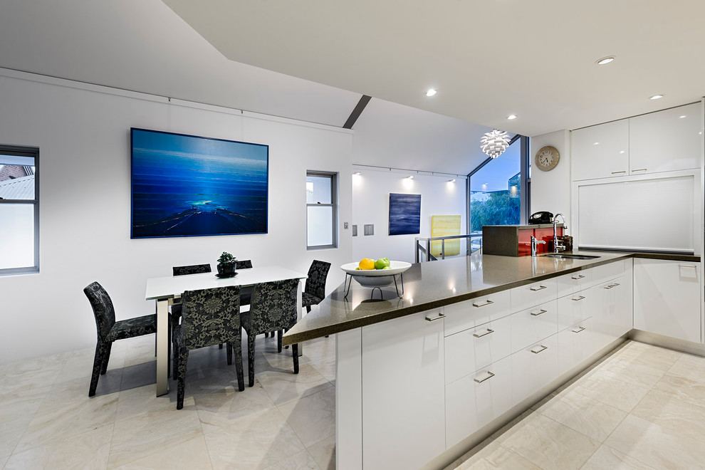 Photo of a contemporary eat-in kitchen in Perth with a single-bowl sink, flat-panel cabinets and white cabinets.