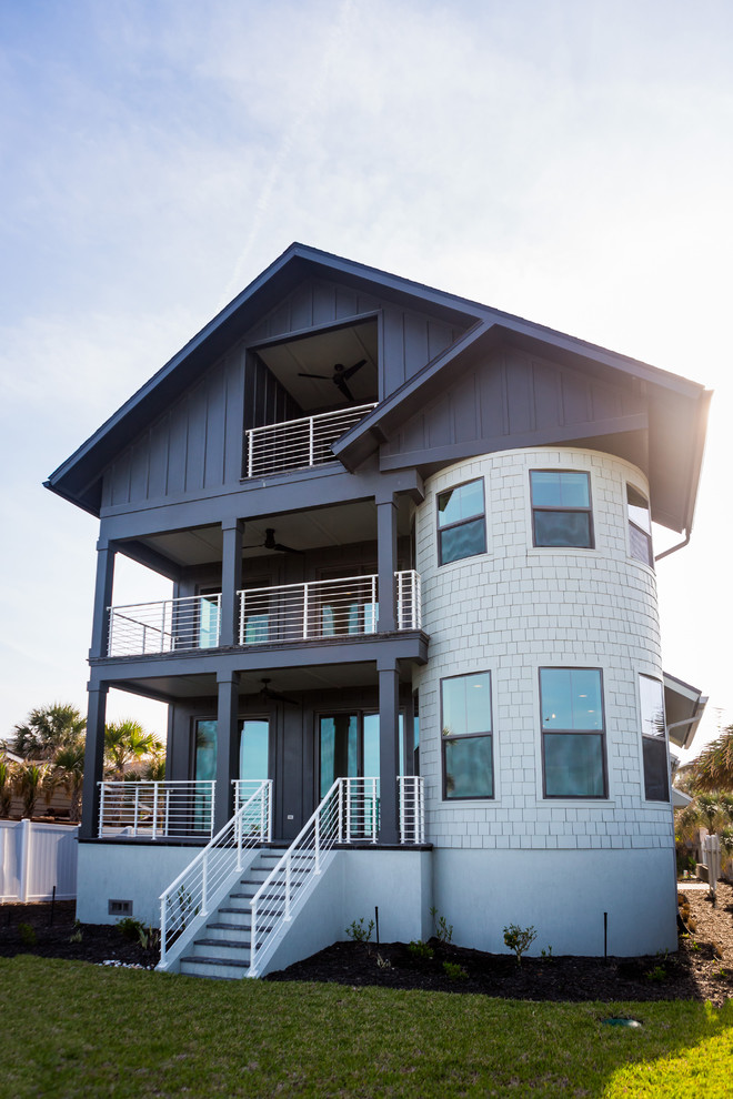 Inspiration for a large beach style three-storey grey exterior in Jacksonville with wood siding.