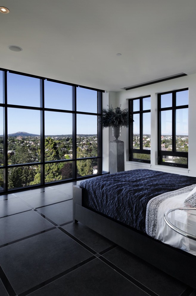 Inspiration for a contemporary bedroom with white walls and black floor.