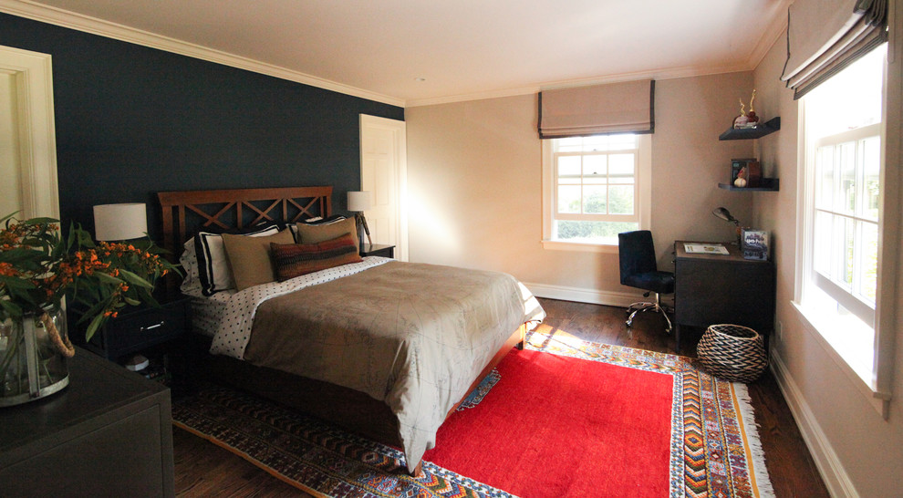 Photo of a mid-sized transitional bedroom in New York with blue walls and medium hardwood floors.