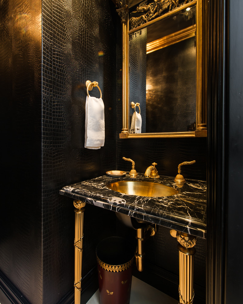 Photo of a traditional powder room in Los Angeles with a console sink and black walls.