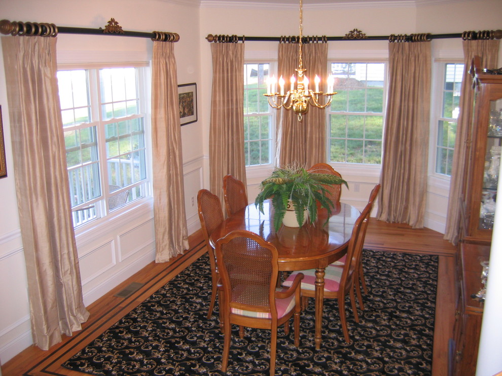 This is an example of a traditional separate dining room in New York with carpet.