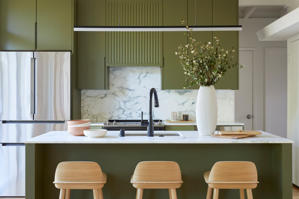 Small midcentury single-wall open plan kitchen in San Francisco with an undermount sink, flat-panel cabinets, green cabinets, marble benchtops, white splashback, marble splashback, stainless steel appliances, medium hardwood floors, with island, brown floor, white benchtop and exposed beam.