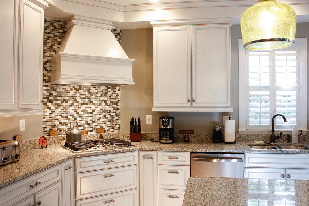 Inspiration for a mid-sized transitional l-shaped medium tone wood floor open concept kitchen remodel in Baltimore with white cabinets, granite countertops, multicolored backsplash, matchstick tile backsplash, stainless steel appliances and an island