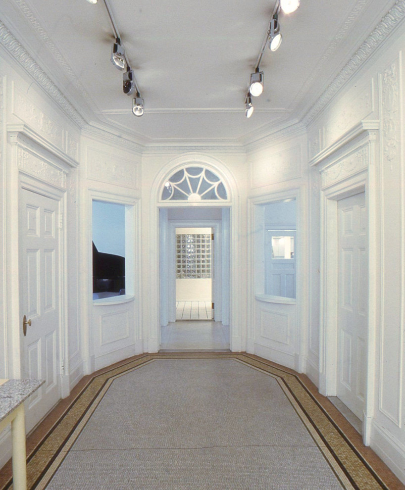 Photo of an expansive modern foyer in New York with white walls, marble floors, a double front door and a white front door.