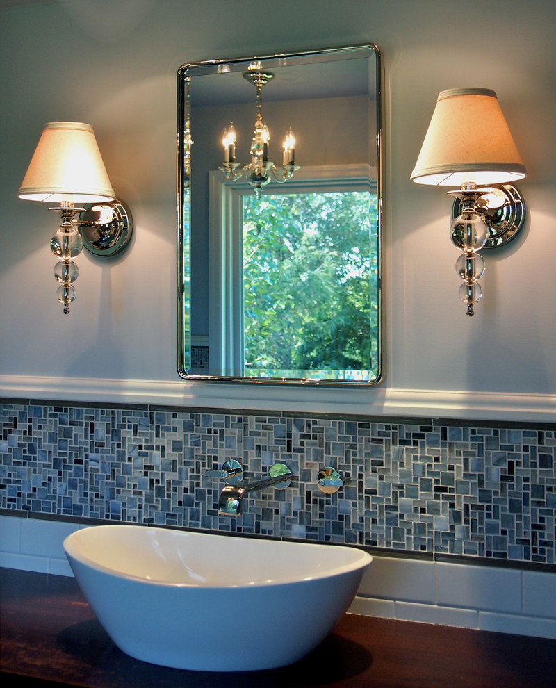 Inspiration for a large transitional master blue tile and mosaic tile porcelain tile freestanding bathtub remodel with a vessel sink, furniture-like cabinets, dark wood cabinets, wood countertops, a one-piece toilet and blue walls