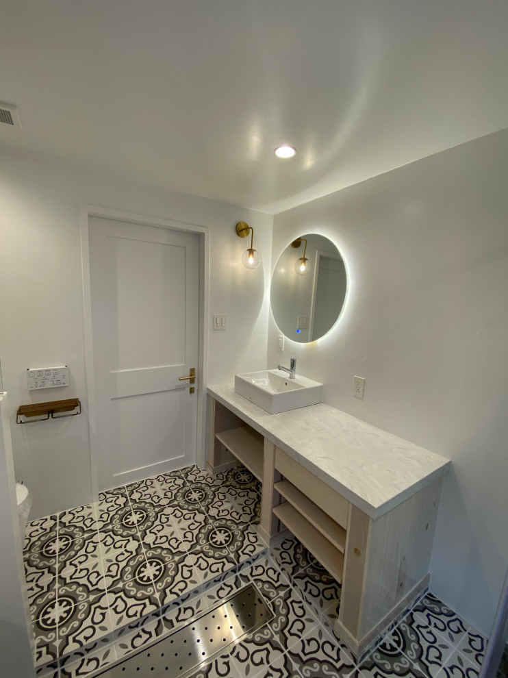 Photo of a mid-sized modern master bathroom in Tokyo with open cabinets, white cabinets, a freestanding tub, a corner shower, a one-piece toilet, white tile, subway tile, white walls, cement tiles, a vessel sink, limestone benchtops, multi-coloured floor, a hinged shower door, white benchtops, an enclosed toilet, a single vanity, a built-in vanity, timber and planked wall panelling.