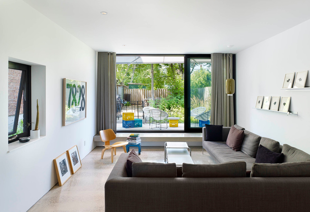 Small minimalist open concept concrete floor living room photo in Toronto with white walls