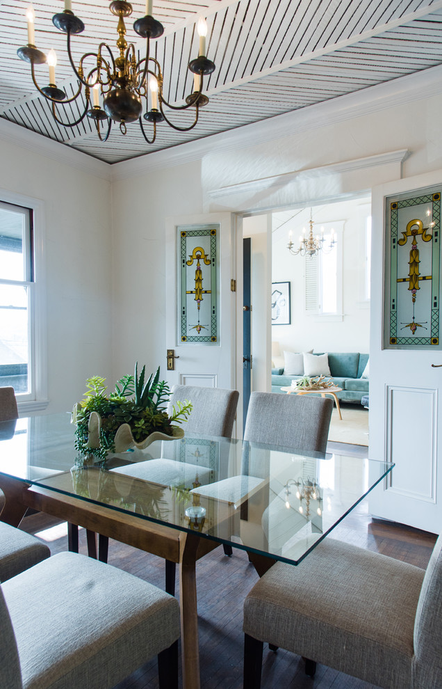 Beach style separate dining room in San Francisco with white walls, dark hardwood floors and brown floor.