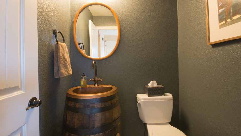 This is an example of a small traditional powder room in Denver with a drop-in sink, distressed cabinets, copper benchtops, a two-piece toilet and grey walls.