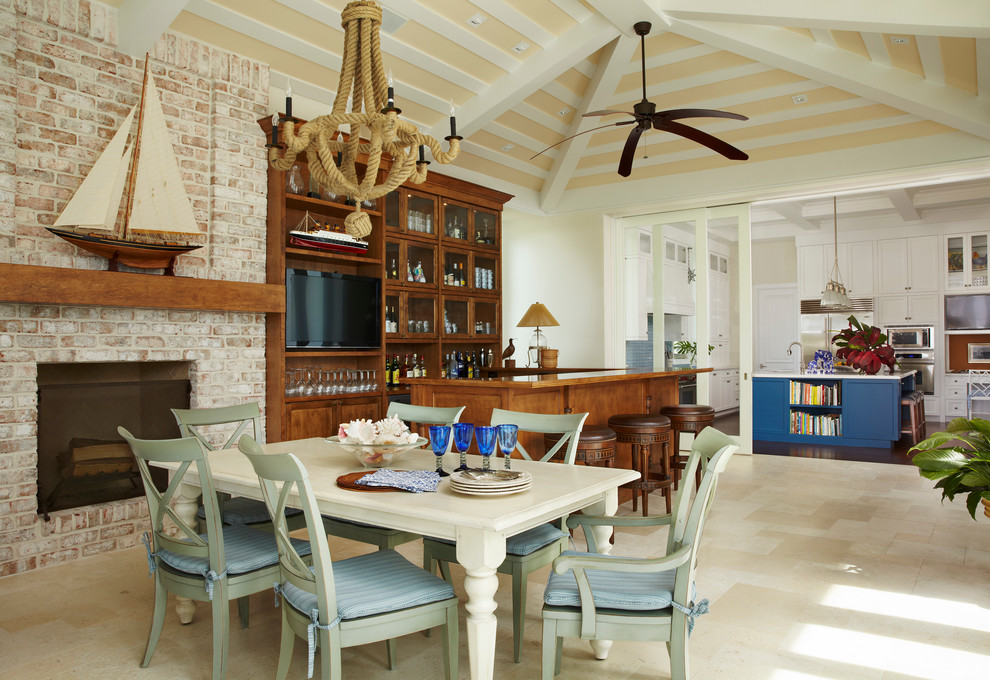 Tropical open plan dining in Miami with white walls, a standard fireplace and a brick fireplace surround.