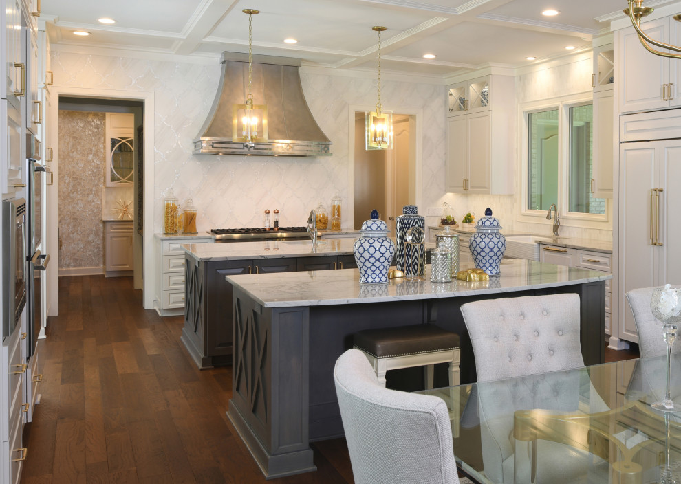 Photo of a large eclectic u-shaped eat-in kitchen in Houston with an undermount sink, raised-panel cabinets, white cabinets, marble benchtops, white splashback, marble splashback, stainless steel appliances, dark hardwood floors, multiple islands, brown floor and white benchtop.