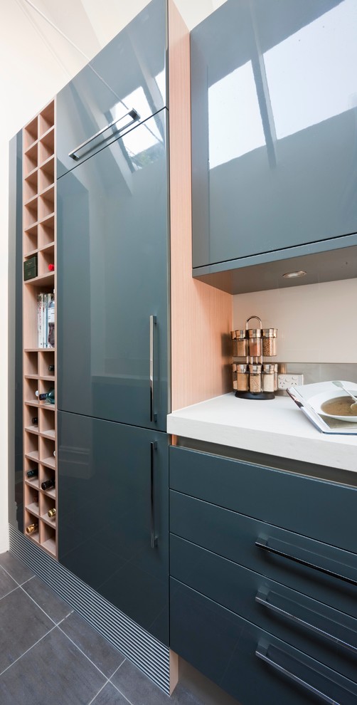 This is an example of a mid-sized contemporary galley eat-in kitchen in Other with an undermount sink, grey cabinets, metallic splashback, stainless steel appliances, ceramic floors and with island.