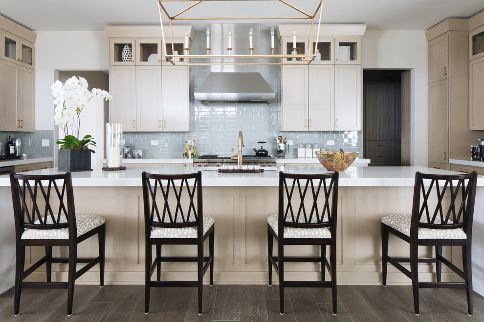 Inspiration for a large transitional u-shaped medium tone wood floor and brown floor kitchen remodel in Chicago with an undermount sink, shaker cabinets, beige cabinets, quartz countertops, glass tile backsplash, stainless steel appliances, an island and white countertops